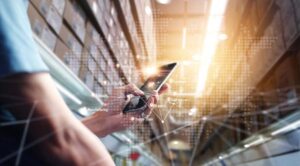 Man using smartphone checking on global logistics network distribution